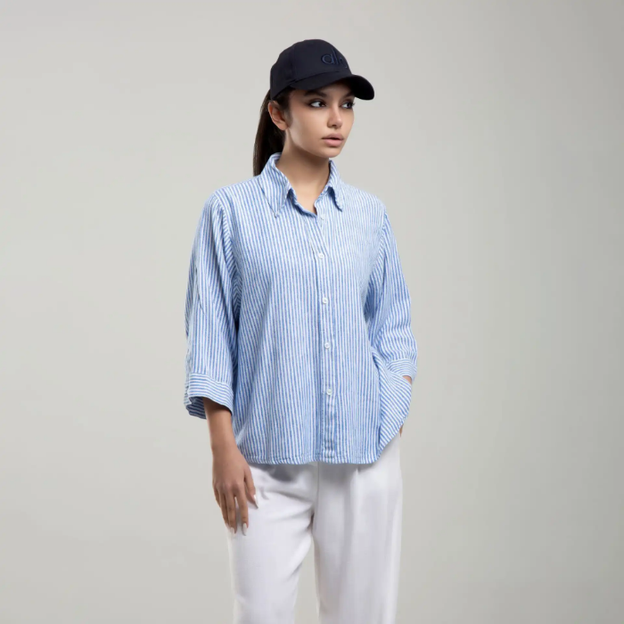 شومیز راه راه زنانه برند بهبود (Behboud) در رنگ‌های متنوع آبی، مشکی، کرم و صورتی.